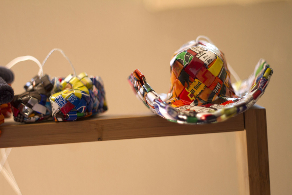 A collection of crafts Jose Deras constructed from recycled materials, including a small, colorful hat. Deras sells his crafts at Volleyball Latino games to make money toward his eventual self-sufficiency. (Shadowproof / Kevin J. Beaty)