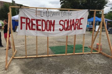 Freedom Square banner greets those who visit the encampment. Photo by Kevin Gosztola