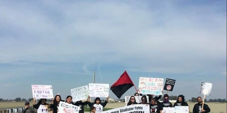 Families gather outside the state prison in Corcoran, California, to protest prisoner fights and lockdown conditions. (Credit: IWOC)